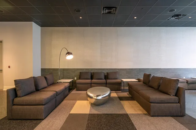 a room with pool table and windows