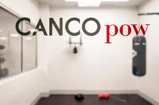 a sign that is on a brick wall in front of a building