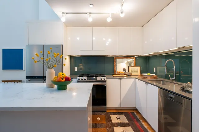 a kitchen with a sink a counter top space a sink and cabinets