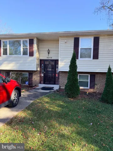 a view of a house with a yard and garage