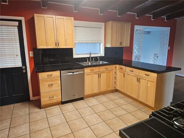 a kitchen with a sink a stove and cabinets