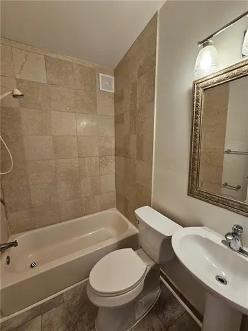 a bathroom with a toilet a sink and bathtub