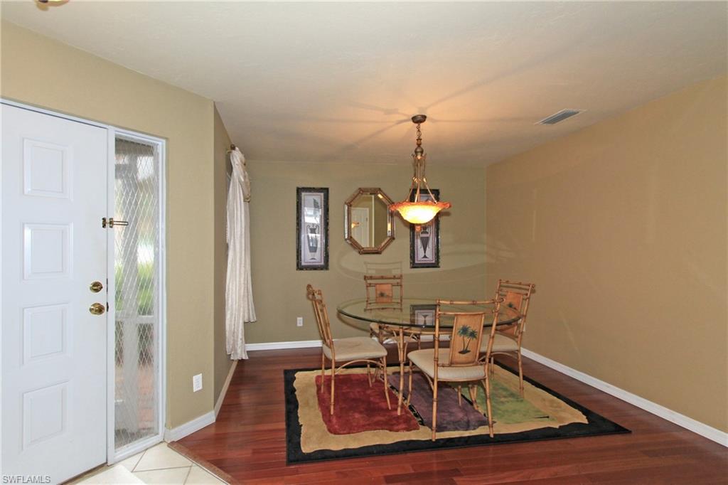 124 Napa Ridge Way Naples, FL 34119 - Photo 8 of 16 a view of a dining room with furniture