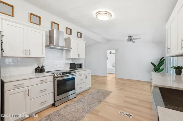 a kitchen with cabinets and steel stainless steel appliances