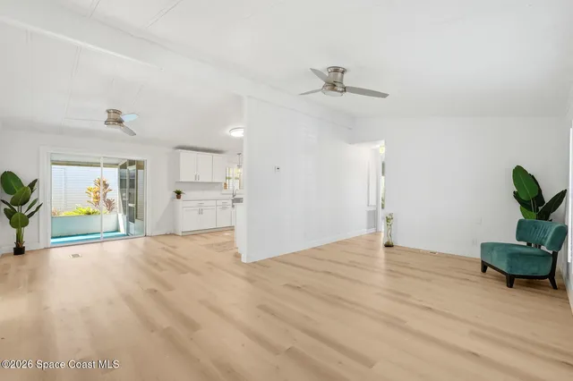 a view of an empty room and wooden floor