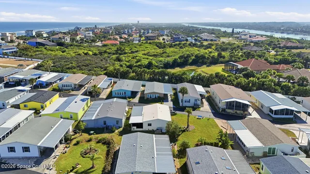 an aerial view of a house with a garden and lake view