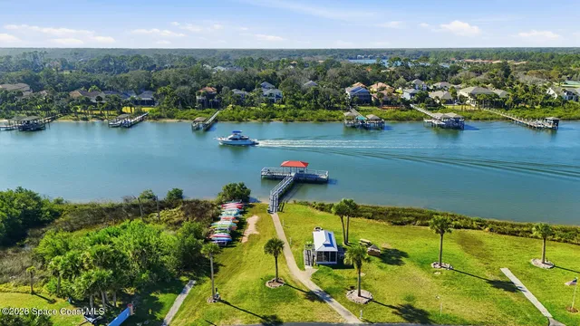 a view of a lake with a table chairs and a fire pit
