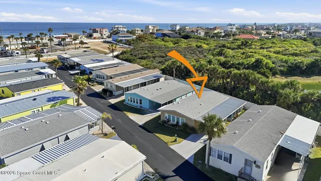 an aerial view of a house with a swimming pool outdoor seating and yard