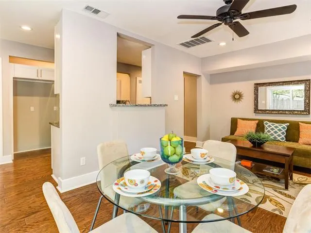 a view of empty room with wooden floor