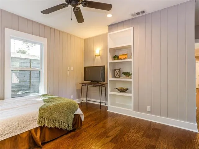 a kitchen with stainless steel appliances granite countertop white cabinets and a stove a refrigerator with wooden floor