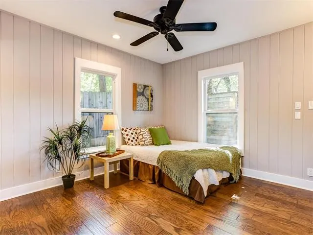 a spacious bedroom with a bed and a dresser