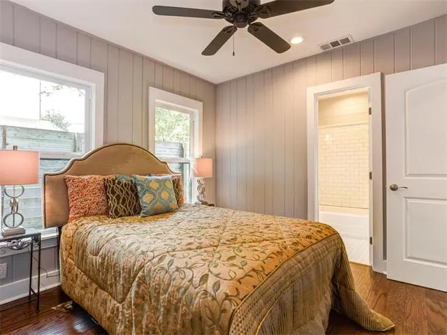a bedroom with a large bed and a potted plant