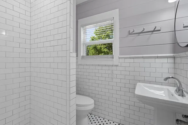 a bathroom with a sink a mirror and shower