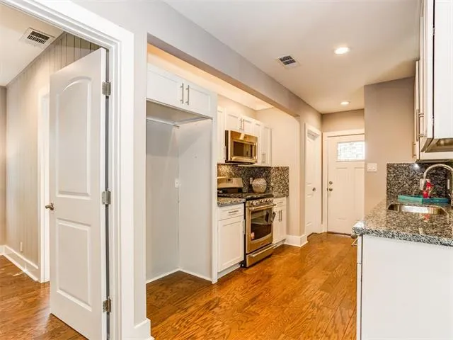a kitchen with stainless steel appliances granite countertop a sink and cabinets