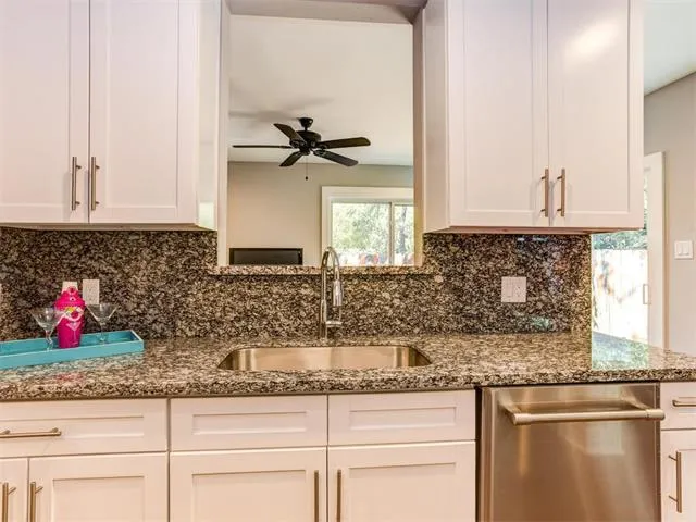 a kitchen with refrigerator a stove and cabinets