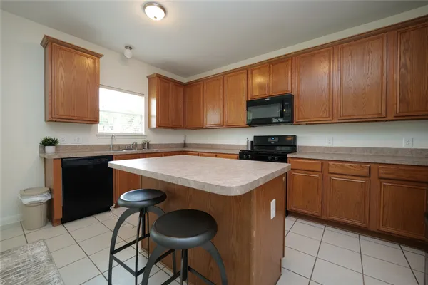 a kitchen with stainless steel appliances granite countertop a refrigerator stove microwave and sink
