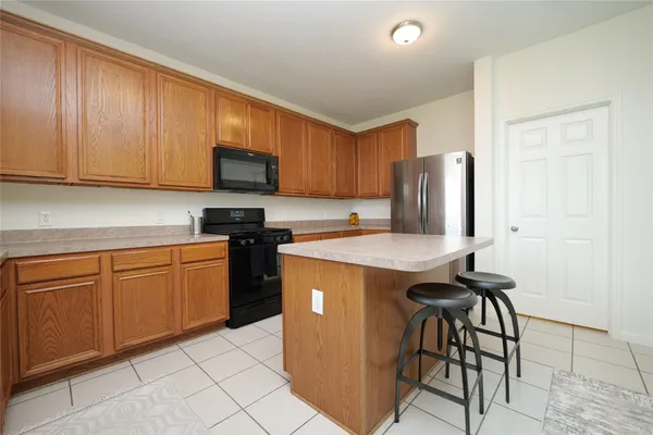 a kitchen with granite countertop cabinets stainless steel appliances and wooden cabinets