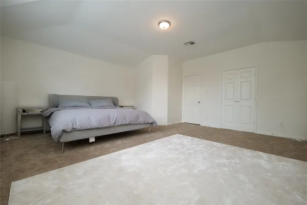a spacious bathroom with a double vanity sink and mirror