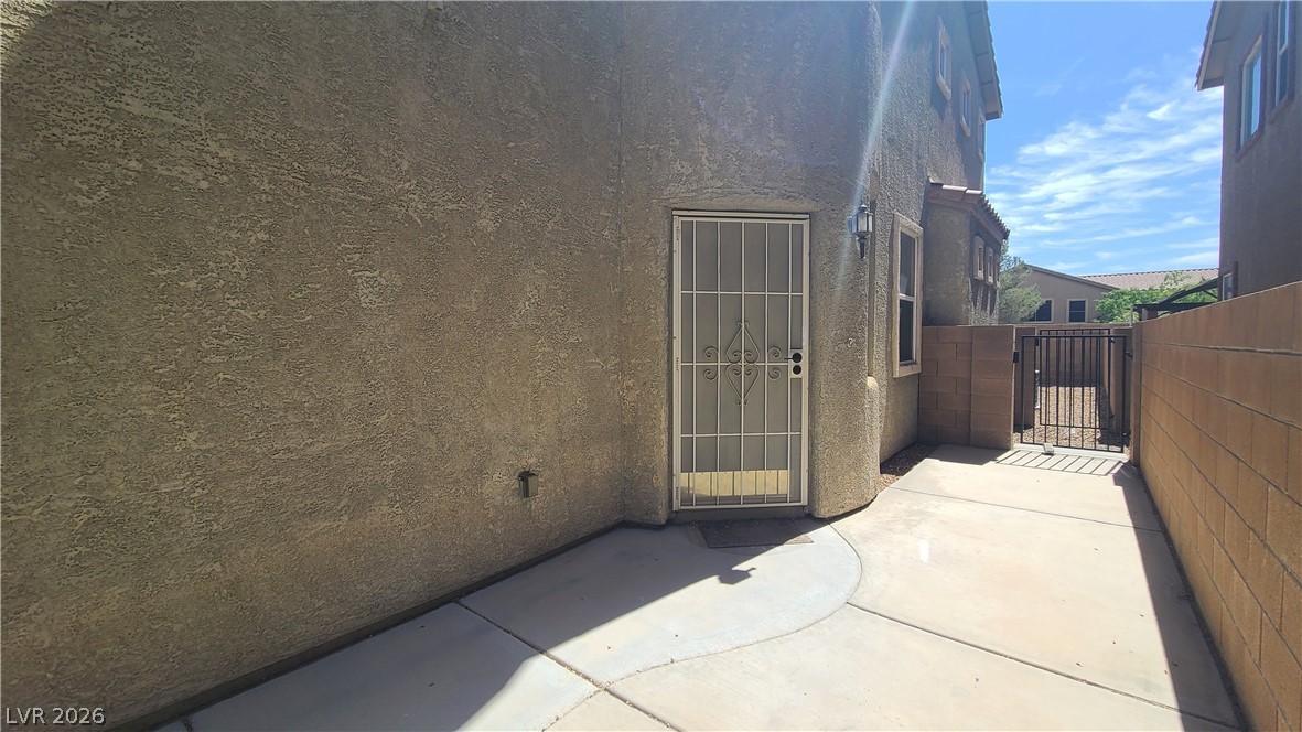 8944 Rutherford Grove Street Las Vegas, NV 89148 - Photo 2 of 35 Secure entry and walled courtyard offer a private outdoor living space.