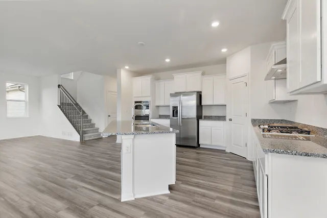 a kitchen with refrigerator and cabinets