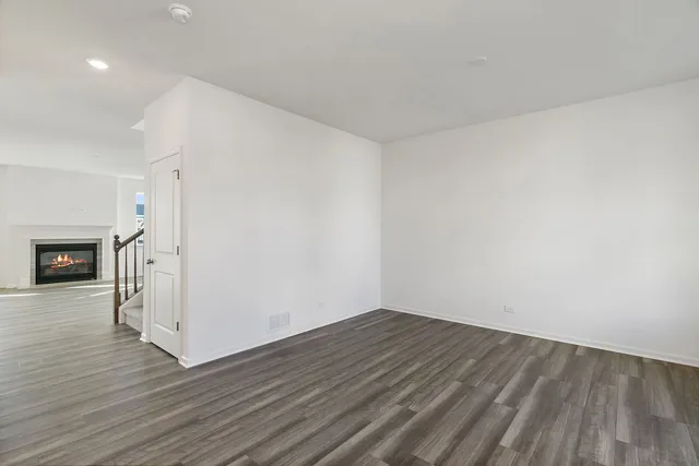 a view of a room with wooden floor and a fireplace