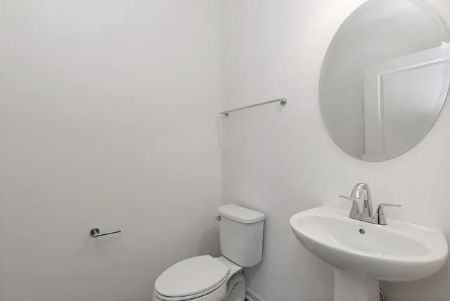 a bathroom with a sink a toilet and mirror