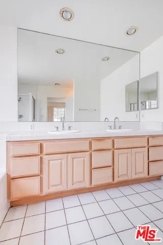 a bathroom with a tub sink and mirror