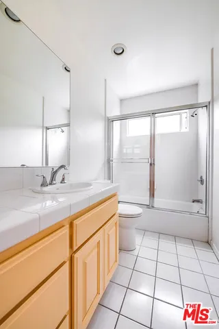 a view of a backyard with table and chairs potted plants and a patio