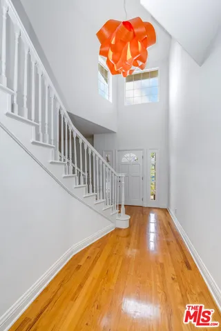 a view of a big room with wooden floor and a window
