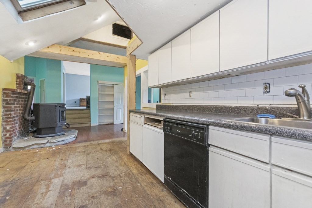 10 Marcius Road Worcester, MA 01607 - Photo 3 of 19 a kitchen with granite countertop a sink a stove and cabinets