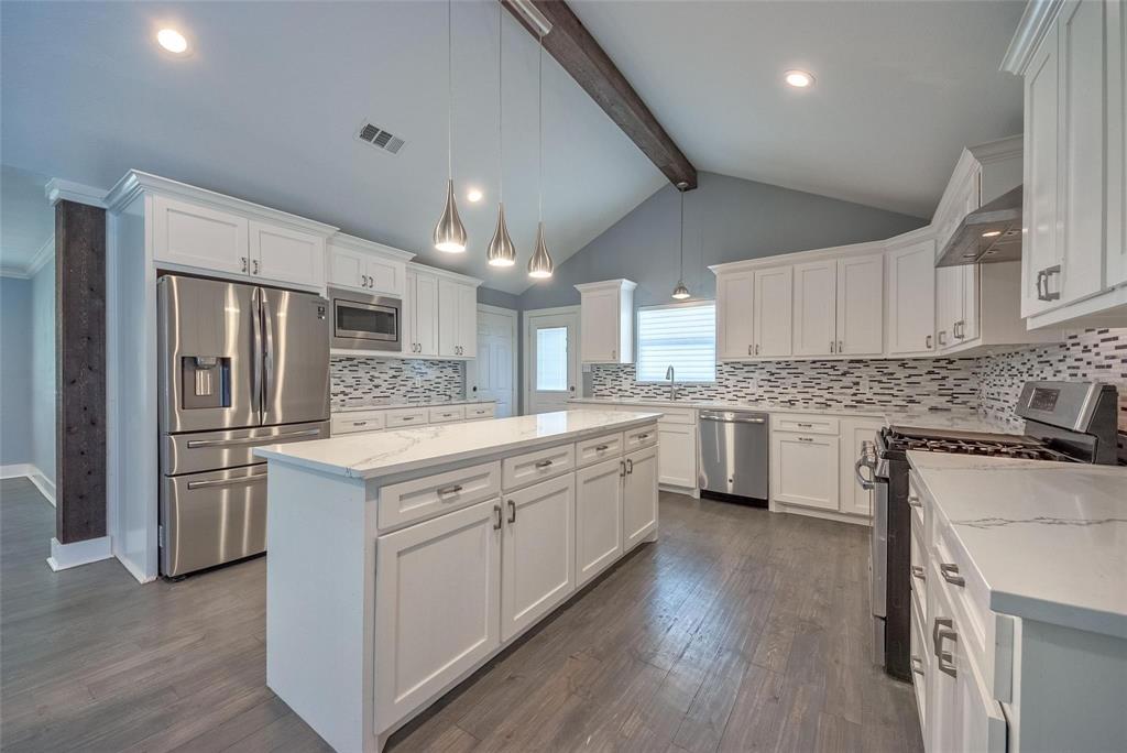11224 Jamestown Road Dallas, TX 75230 - Photo 11 of 40 a kitchen with white cabinets and stainless steel appliances