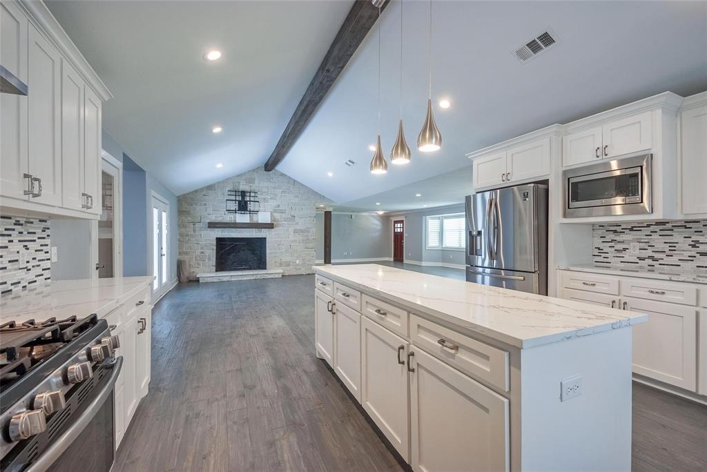 11224 Jamestown Road Dallas, TX 75230 - Photo 13 of 40 a large kitchen with a stove and a sink