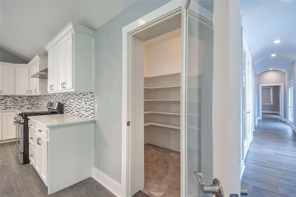 11224 Jamestown Road Dallas, TX 75230 - Photo 14 of 40 a kitchen with a refrigerator and white cabinets
