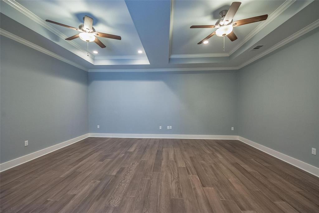 11224 Jamestown Road Dallas, TX 75230 - Photo 17 of 40 a view of an empty room with a ceiling fan and wooden floor