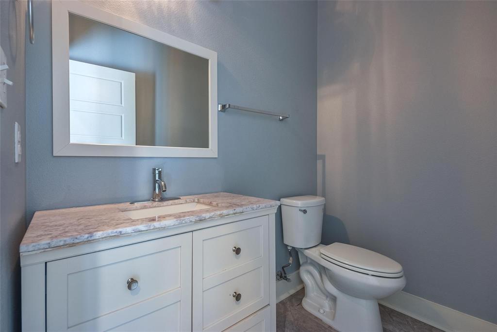 11224 Jamestown Road Dallas, TX 75230 - Photo 18 of 40 a bathroom with a granite countertop toilet sink and mirror