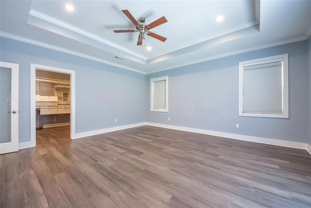 11224 Jamestown Road Dallas, TX 75230 - Photo 22 of 40 an empty room with wooden floor and windows