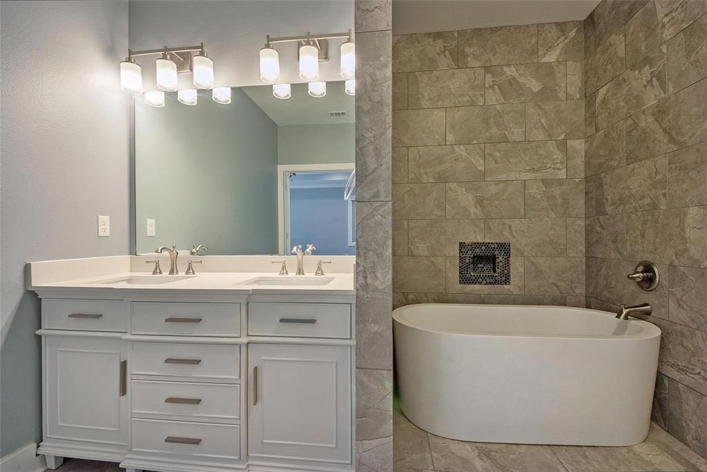 11224 Jamestown Road Dallas, TX 75230 - Photo 24 of 40 a bathroom with a bathtub a sink and a mirror