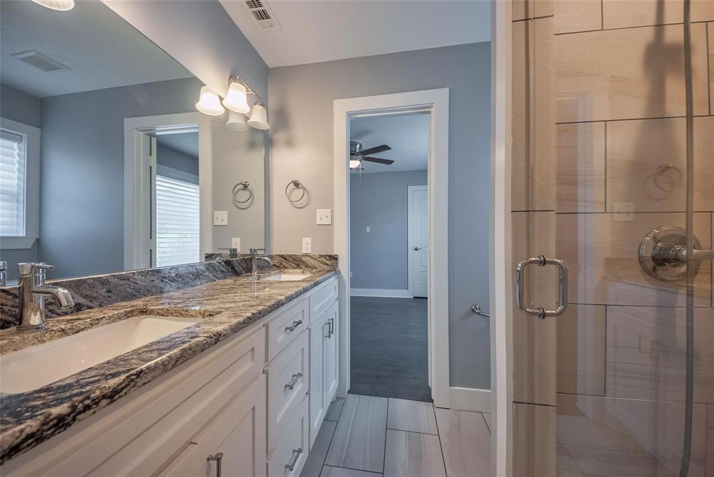 11224 Jamestown Road Dallas, TX 75230 - Photo 29 of 40 a bathroom with a granite countertop sink two mirror and shower