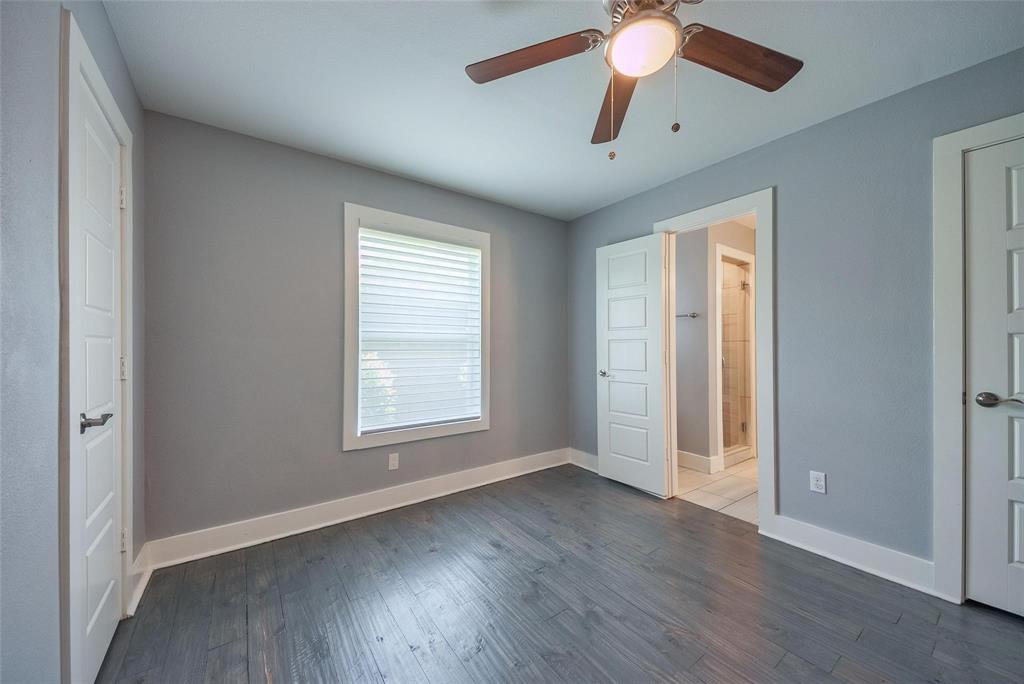 11224 Jamestown Road Dallas, TX 75230 - Photo 30 of 40 an empty room with wooden floor chandelier fan and windows