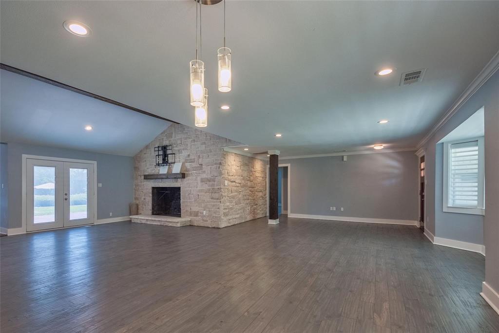 11224 Jamestown Road Dallas, TX 75230 - Photo 7 of 40 an empty room with wooden floor and chandelier
