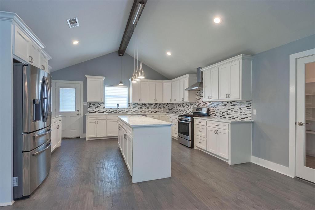 11224 Jamestown Road Dallas, TX 75230 - Photo 10 of 40 a kitchen with a refrigerator and white cabinets
