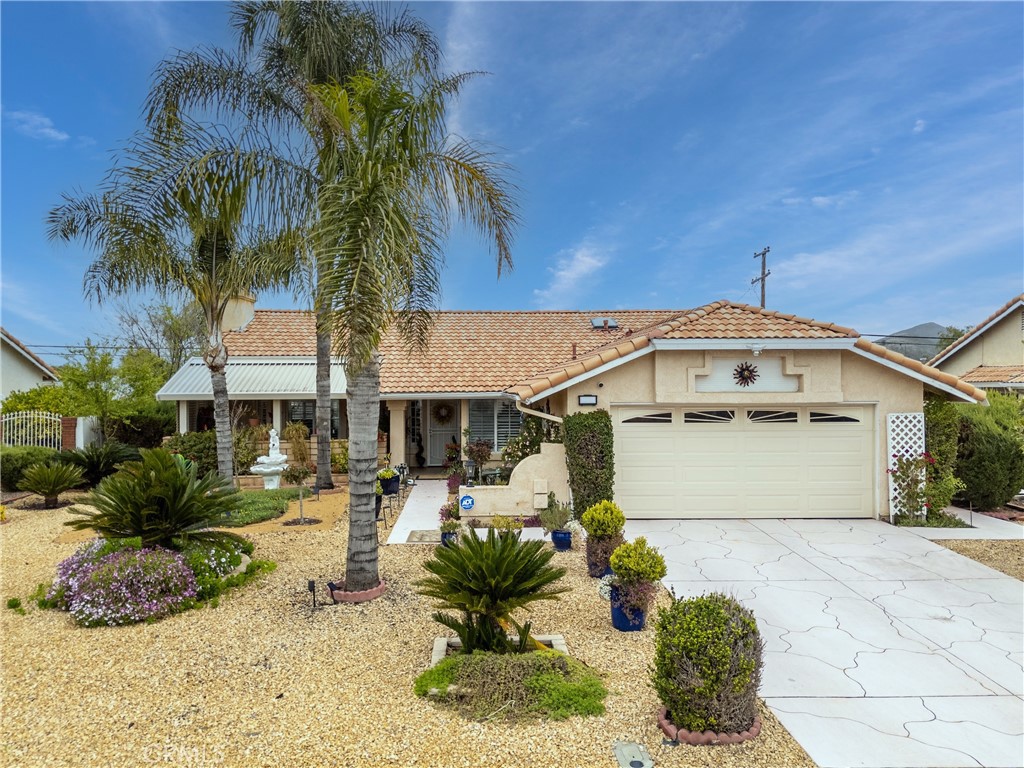 26592 Braddock Road Menifee, CA 92586 - Photo 1 of 25 a front view of a house with garden