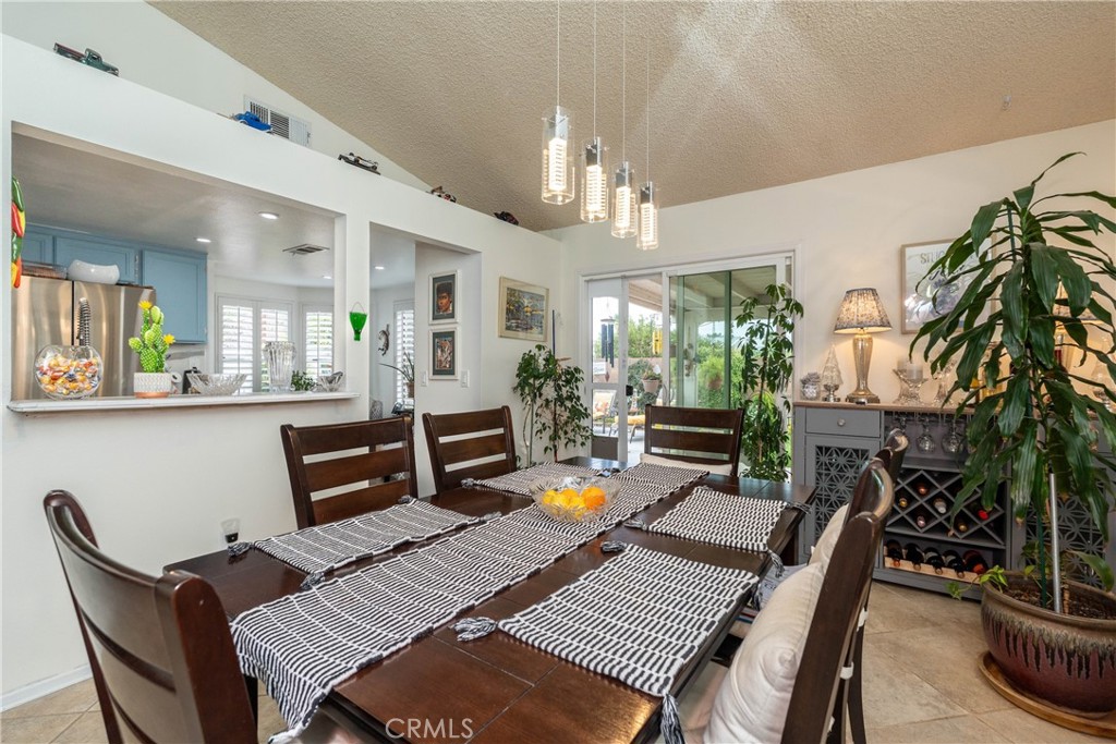 26592 Braddock Road Menifee, CA 92586 - Photo 11 of 25 a living room with furniture a chandelier and a dining table