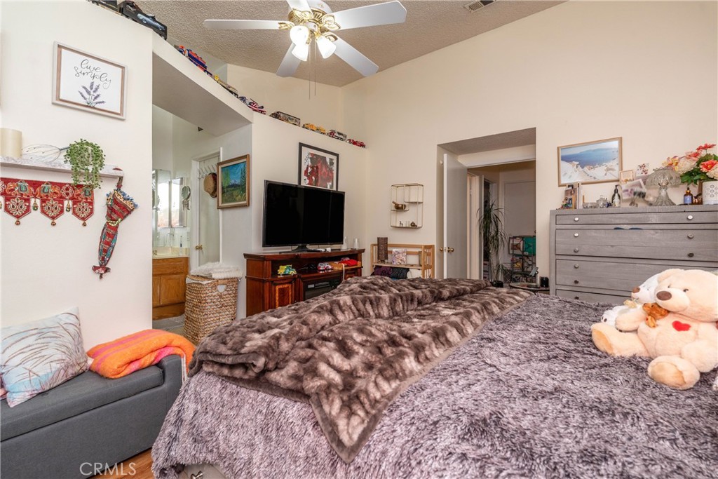 26592 Braddock Road Menifee, CA 92586 - Photo 14 of 25 a bedroom with furniture and a flat screen tv