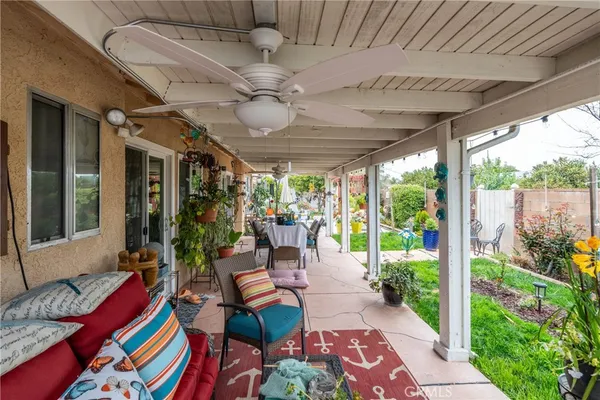 a view of the patio with dining table and chairs potted plants