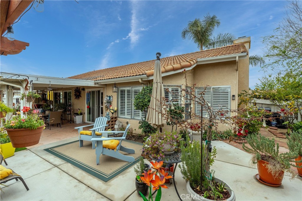 26592 Braddock Road Menifee, CA 92586 - Photo 22 of 25 a view of the patio with dining table and chairs potted plants