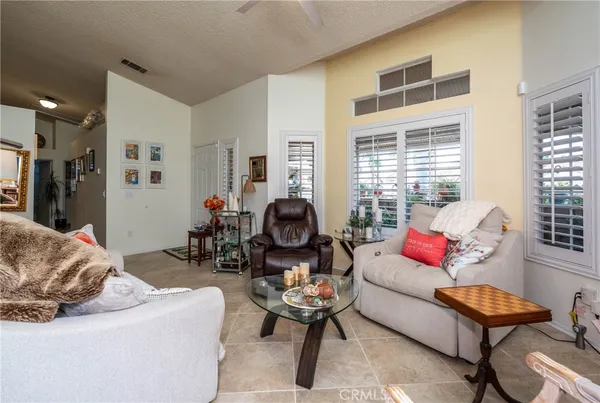 a living room with furniture a rug and a large window