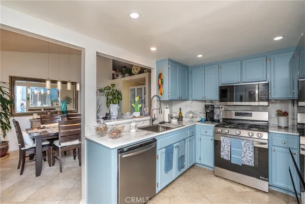 a kitchen with a sink stove and cabinets
