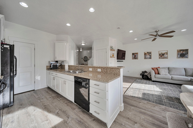 11730 South Shadow Lane Draper, UT 84020 - Photo 24 of 24 Kitchen featuring a peninsula, white cabinetry, open floor plan, light stone countertops, and light wood-style flooring