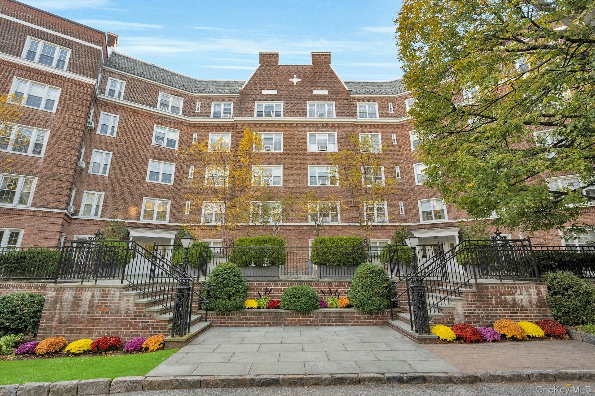 5 Midland Gardens, Unit 3M Bronxville, NY 10708 - Photo 2 of 19 View of apartment building / complex with a fenced front yard and stairs